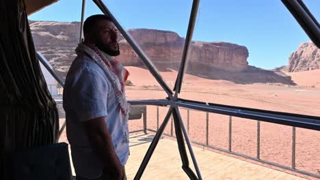 man-looking-at-the-views-from-his-bubble-camp-to-wadi-rum
