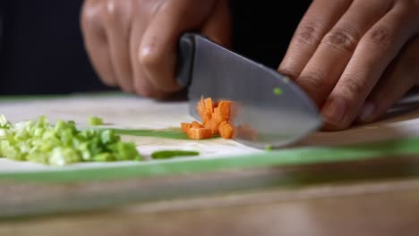 Chopping-carrots-after-green-onions---isolated-close-up