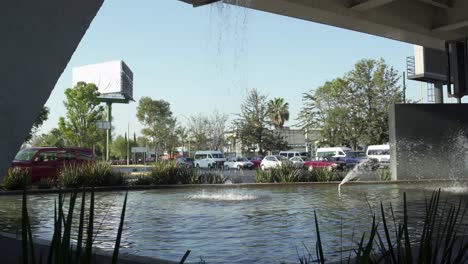 Urban-scene:-Vehicles-passing-by-close-to-a-parking