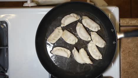 Japanese-dumplings-steaming-in-a-frying-pan---overhead-view