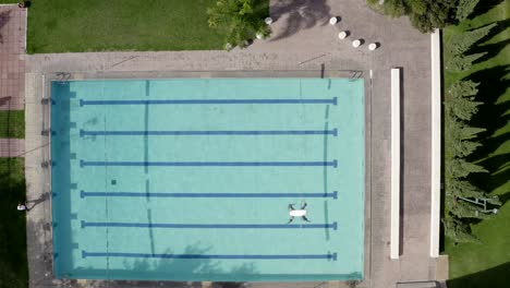 Wide-Aerial-View-of-Small-Drone-Flying-Over-the-Outdoor-Swimming-Pool