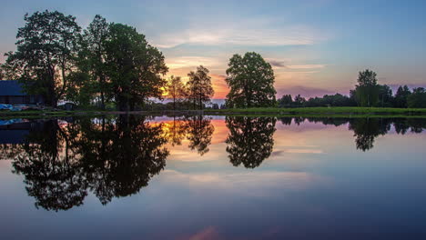 Pond-reflection-of-trees-and-clouds-sunrise-timelapse