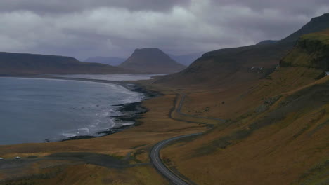 Mountains,-valley-and-coast,-with-roadways-along-the-coast-on-an-overcast-day-in-Iceland