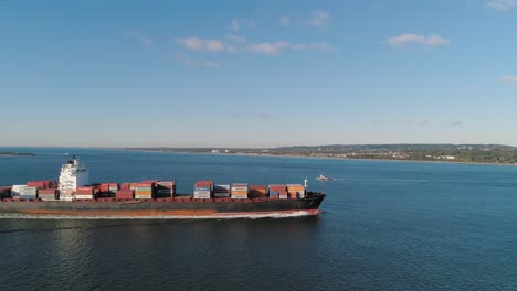 Aerial-Orbiting-Shot-of-Freighter-in-the-New-York-Harbor-with-Verrazano-Bridge-in-the-Distance