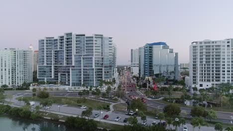 Aerial-Reverse-Dolly-Over-a-Marina-Revealing-Downtown-Sarasota-During-Sunrise