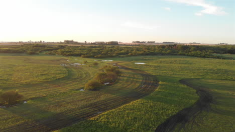 Aerial-Drone-Shot-of-Muddy-Field-at-Sunset