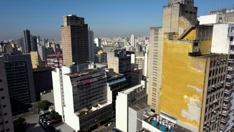 Drone-shot-in-middle-of-colorful-buildings-in-Consolacao,-sunny-Sao-Paulo,-Brazil