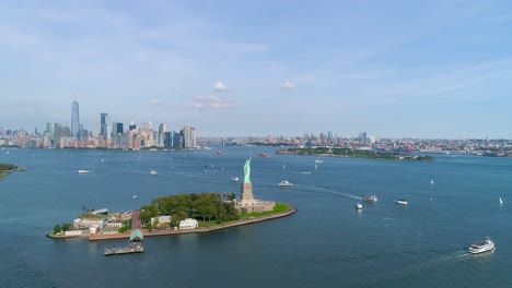 Aerial-Shot-of-Helicopter-Flyby-Over-Statue-of-Liberty-and-the-New-York-City-Skyline-in-Slow-Motion