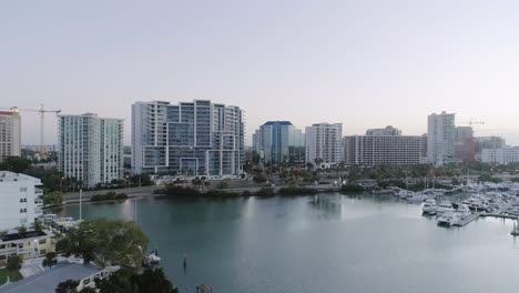 Aerial-Forward-Dolly-Over-Bay-into-Downtown-Sarasota-During-Sunrise