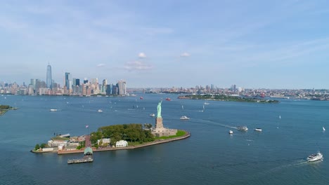 Aerial-Shot-of-Helicopter-Flyby-Over-Statue-of-Liberty-and-the-New-York-City-Skyline