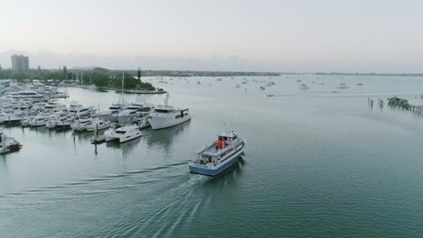 Aerial-Orbit-Shot-Approaching-Fishing-Boat-in-Sarasota-Bay-Leaving-Marina-During-Sunrise