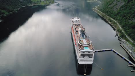 Aerial-Shot-of-Cruise-Ship-Docked-in-Geirangerfjord-Revealing-Landscape-of-Norway