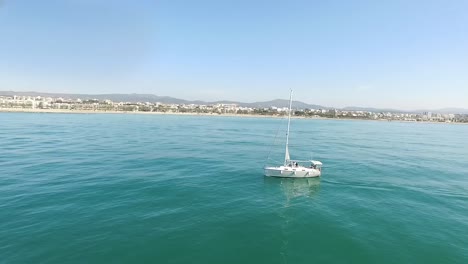 Sailing-boat-with-a-mediterranean-village