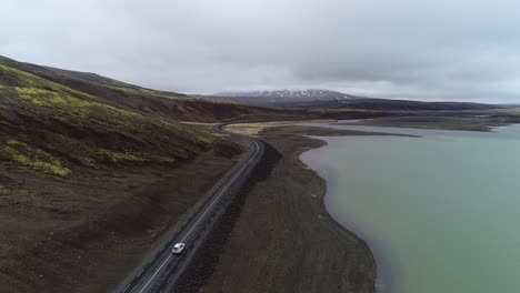 Aerial-Follow-Behind-Car-Driving-through-the-valley-of-the-Kaldidalur-Mountain-and-Sandkluftavatn