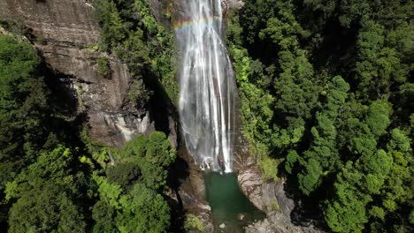 Aerial-view-of-amazing-waterfall-forest-and-rocky-mountain,-Westland,-New-Zealand