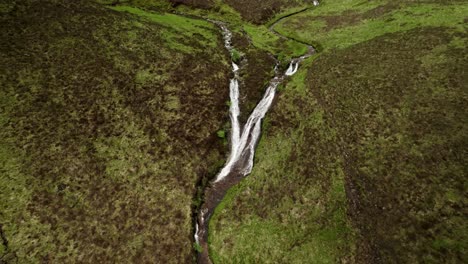 Closeup-Detailed-Aerial-Shot-of-Two-Waterfalls-Converging-In-Skye,-Scotland
