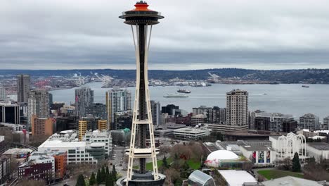 Seattle,-Washington-city-skyline-featuring-the-bay-and-Space-Needle---aerial-pull-back-reveal
