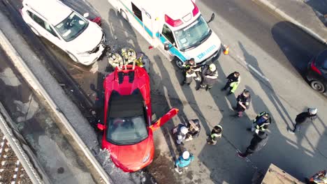26th-February-2023---Aerial-Overhead-View-Of-Red-Lamborghini-Car-Crash-On-Steeles-Avenue-Bridge,-Brampton-In-Canada