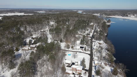 Slow-aerial-descent-over-houses-and-trees-beside-the-Kennebec-River