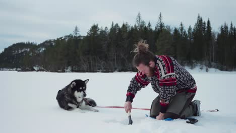Bearded-Norwegian-Guy-Is-Breaking-Frozen-Lake-Using-A-Handy-Wood-Axe