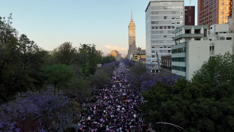 Aerial-view-of-a-people-protesting-on-the-streets-of-Mexico-city,-during-sunset