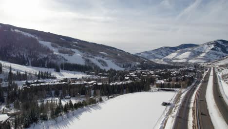 Drone-shot-of-a-busy-highway-and-a-ski-resort-in-Colorado