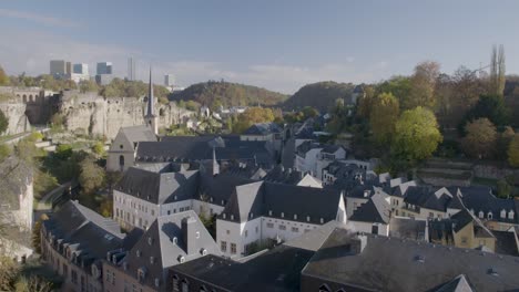 Famous-old-town-of-Luxembourg,-look-over-rooftops-with-smoking-chimney-sunny-day