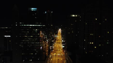 Nightly-soaring-drone-shot-over-a-boulevard-between-the-skyscrapers-of-Toronto-in-Canada