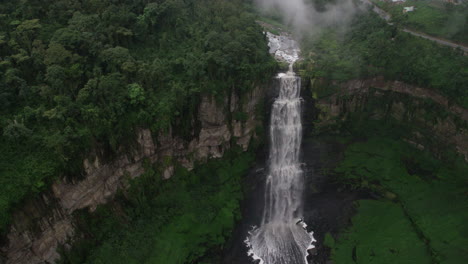 cinematic-aerial-shot-of-huge-epic-waterfall-in-the-jungle-rainforest,-flowing-river-in-the-mountains