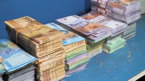 Pilas-De-Dinero-En-Moneda,-Pila-De-Rupias-Indonesias-En-Cámara-Lenta,-Diferentes-Valores-De-Efectivo-En-Papel