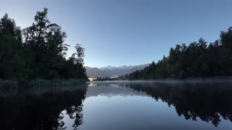 Peaceful,-foggy-sunrise-at-Lake-Matheson,-West-Coast-New-Zealand