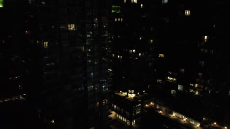 Nighttime-drone-flight-over-Toronto-city-shows-the-illuminated-buildings-and-houses