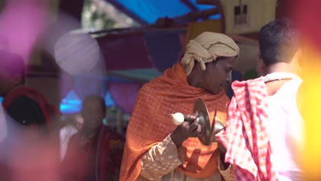 A-priest-plays-a-tambourine-and-sings-in-the-temple-premises