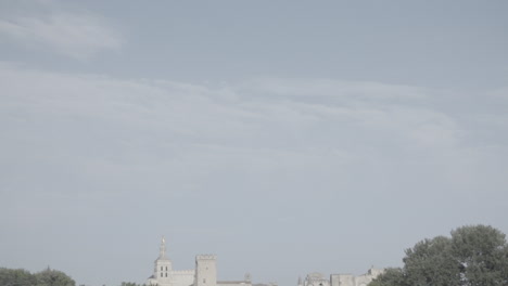 Revealing-shot-of-from-the-sky-looking-over-Avignon-France-on-a-sunny-day-in-slowmotion-LOG