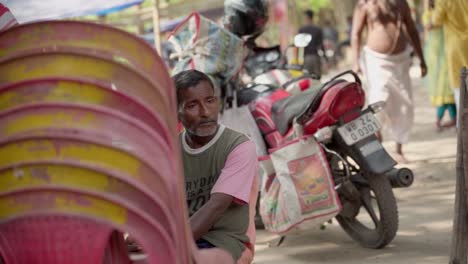 Poor-sad-old-man-sitting-beside-chairs-outside-and,looking-away-slow-motion