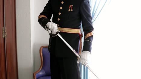 Man-in-military-uniform-sheathing-a-sword-in-slow-motion