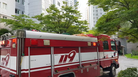 Side-view-Of-119-Firetruck-near-Apartment-in-South-Korea,-Flashing-Emergency-Lights