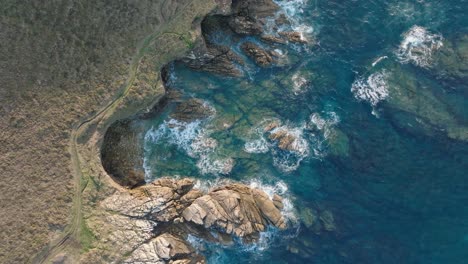 Flight-Over-Rugged-Landscape-Of-Cabo-de-San-Adrian-Peninsula-In-Spain---drone-shot