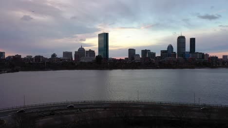 Aerial-view-of-traffic-on-the-Memorial-drive,-cloudy-sunset-in-Boston,-USA---descending,-drone-shot