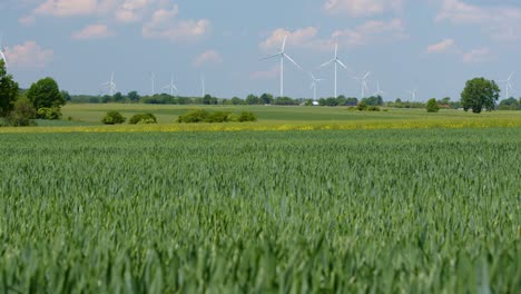 Concept-solution-against-climate-change,-wind-turbines-in-green-countryside