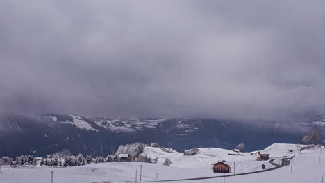 Dramatic-Timelapse-of-Snow-Storm-Engulfs-Mountain-Peaks-with-a-Charming-Wooden-Cabin-Amidst-Dark-Clouds