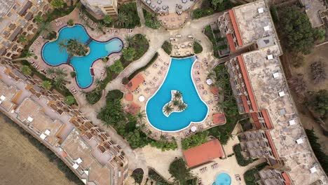 Top-down-aerial-view-of-a-hotel-complex-and-its-surroundings-in-the-Maltese-island-of-Gozo