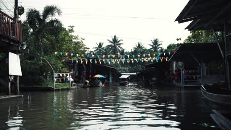 A-boat-sails-through-a-wide-canal-in-Thailand