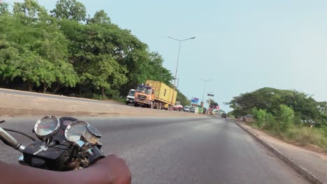 POV-shot-of-motor-rider's-steering-wheel-riding-on-a-highway