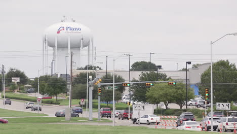 Plano,-Texas-water-tower-next-to-a-busy-road-leading-into-the-city