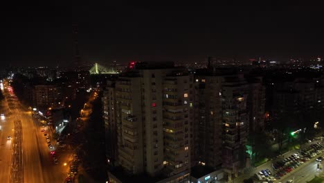 Edificios-De-Gran-Altura-Y-Tráfico-Circulando-Por-Las-Calles-De-Noche-En-Bucarest,-Rumania