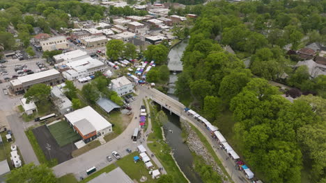 Aerial-View-Of-Booths-And-People-Gathering-By-The-Sager-Creek-During-Dogwood-Festival-In-Siloam-Springs,-Arkansas