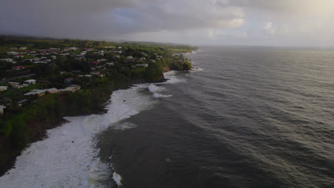 Aerial-slide-and-pan-footage-of-ocean-coast-and-waves-on-water-surface
