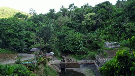 Panoramic-view-of-tropical-river-park-and-rainforest-covered-mountains-in-Baras,-Catanduanes