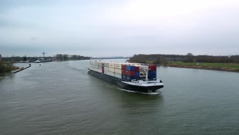 Aerial-View-Of-Felicitas-Cargo-Container-Ship-Navigating-Along-Oude-Maas-Through-Zwijndrecht